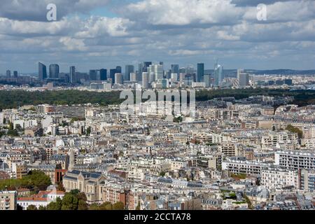 Aerial view of the towers of La Defense, business district of Paris, France, sunny with cloudy sky, parisian buildings and the bois de Boulogne in the Stock Photo