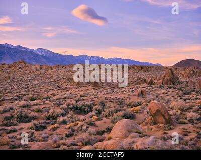 A fluffy cloud floats above an empty desert landscape, Alabama Hills Stock Photo