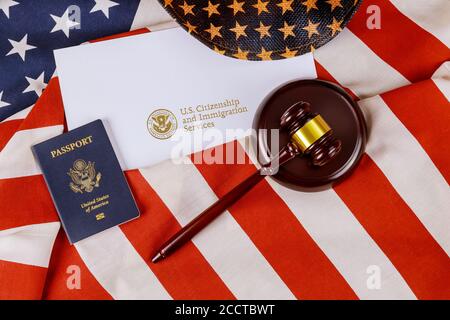 US passport over Letter from U.S. Citizenship and Immigration Services of naturalization with in a judge law gavel Stock Photo