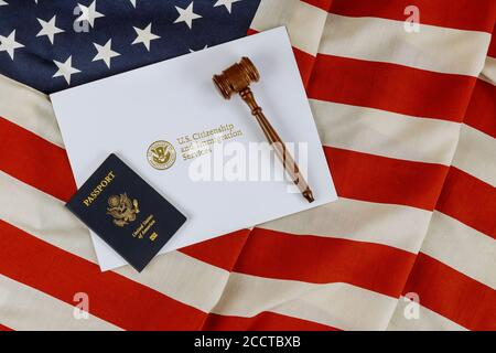 US Passports with wooden judge gavel on American flag on legal world immigration concepts a citizenship Stock Photo