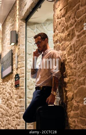 Young man talks on the phone at night. Young businessman Stock Photo