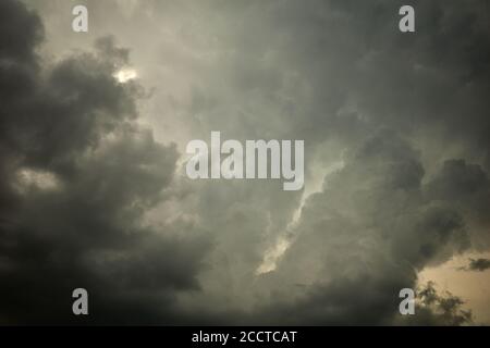 Cloudy sky with gray and yellow fluffy cumulous clouds. It is overcast, the sky or the day is overcast, the sky is completely covered with cloud Stock Photo