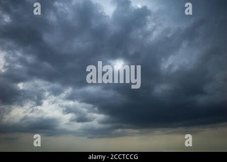 Dark clouds in the dramatic sky. Stratocumulus clouds covered the overcast sky at the day. Stock Photo