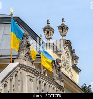 Detail of the facade of St. George's Greek Catholic  Cathedral in Lviv, Ukraine. Entrance decorated with Ukrainian national flags Stock Photo