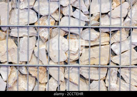 large stones behind wire fences, note shallow depth of field Stock Photo