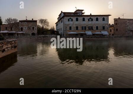 In the center of Bagno Vignoni dominates the old thermal pool. Today the pool is a protected monument and bathing is forbidden here. But the charm of the old bathing place is perfectly preserved. Several cafes and restaurants line the historic site, which has often been the backdrop for films. Stock Photo