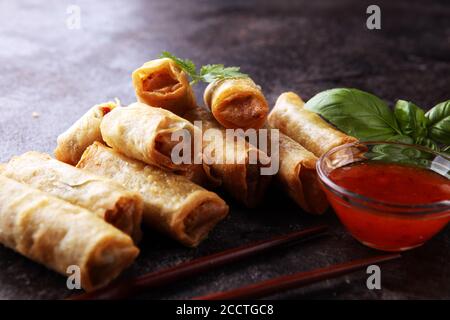 Fried chinese spring rolls with sweet chili sauce on background Stock Photo