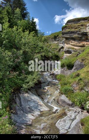 Valse Waterfall Alpine little waterfall in Vals in Switzerland Stock Photo - Alamy