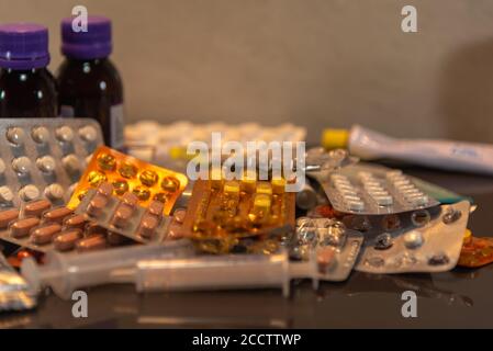 Medicines and medicines. Pack of pills spread on a flat surface. Health health. Bottles and packaging. Syringes. blisters. Items to fight diseases and Stock Photo