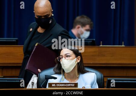 Washington, United States Of America. 24th Aug, 2020. United States Representative Alexandria Ocasio-Cortez (Democrat of New York) and US Representative Ayanna Pressley (Democrat of Massachusetts), are seen as US Postmaster General Louis DeJoy testifies during the House Oversight and Reform Committee hearing titled “Protecting the Timely Delivery of Mail, Medicine, and Mail-in Ballots,” in Rayburn House Office Building on Monday, August 24, 2020. Credit: Tom Williams/Pool via CNP | usage worldwide Credit: dpa/Alamy Live News Stock Photo