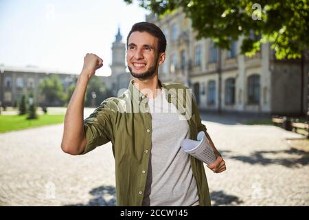 Joyous undergraduate rejoicing at passing an examination Stock Photo