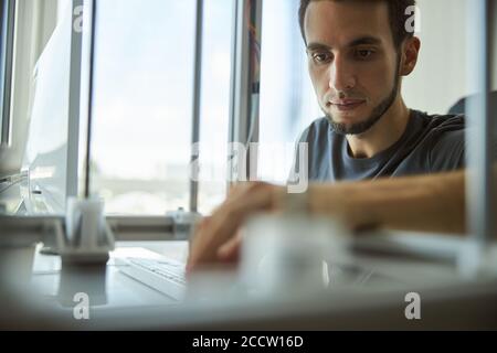 Focused male scientist using a 3D printer Stock Photo