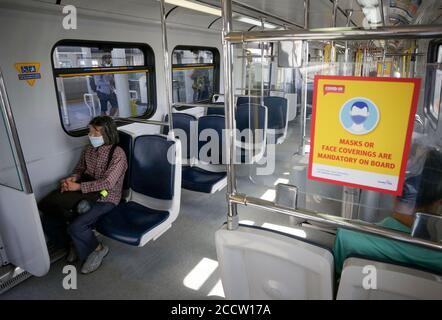 Vancouver, Canada. 24th Aug, 2020. A sign is seen inside a SkyTrain compartment to remind people of wearing face masks in Vancouver, British Columbia, Canada, on Aug. 24, 2020. Anyone on board a TransLink or British Columbia (BC) Transit bus, boat or train and passengers on board BC Ferries vessels are required to wear a face mask beginning Monday to help stop the spread of COVID-19. Credit: Liang Sen/Xinhua/Alamy Live News Stock Photo