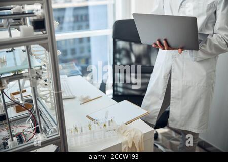 Scientist holding a laptop in his hands Stock Photo