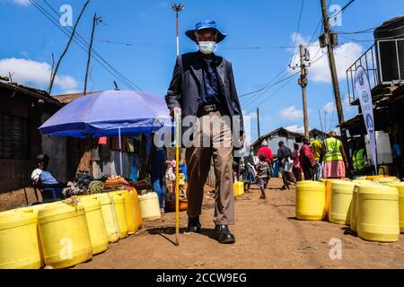 Nairobi, Kenya. 6th Aug, 2020. An elderly man wearing a facemask is . seen walking past the busy streets surrounded by empty water Jerrycans. Credit: Donwilson Odhiambo/SOPA Images/ZUMA Wire/Alamy Live News Stock Photo