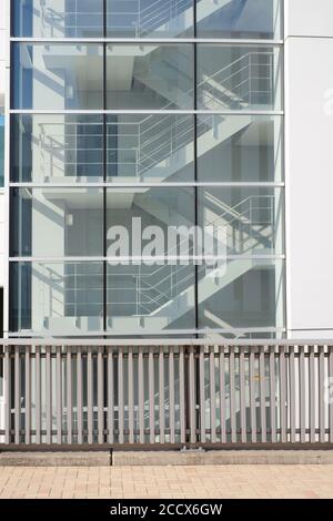 Side view of metal stairs inside the building on exit way connect to underground with sunlight shine through window glass Stock Photo