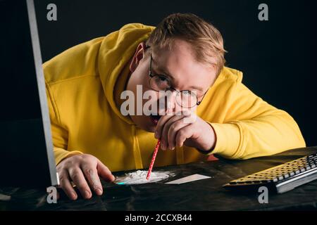 plump guy in glasses is addicted to illegal drugs. close up portrait. leisure,man getting pleasure from cocaine, entertainment. Stock Photo