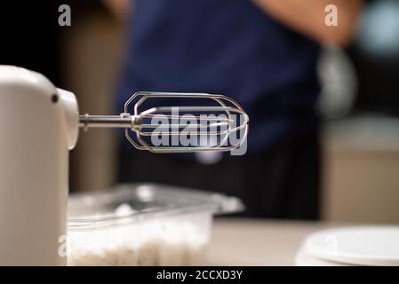 White kitchen machine and stand mixer on a wooden table in a bright design  apartment Stock Photo - Alamy