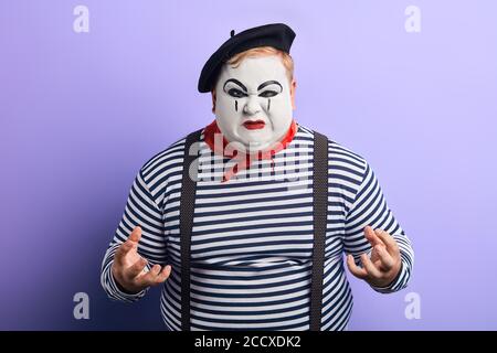 cruel unhappy sad nervous man being in panic, close up photo. isolated blue background. Stock Photo