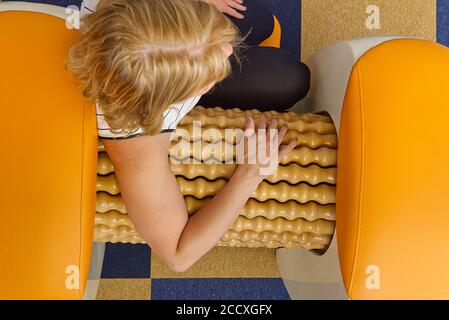 smiling woman making massage for back. Roll Massage machine is a way to  shape the figure. Skin Care, body care concept modern relax massage  equipment Stock Photo - Alamy