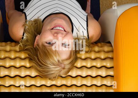 smiling woman making massage for back. Roll Massage machine is a way to  shape the figure. Skin Care, body care concept modern relax massage  equipment Stock Photo - Alamy