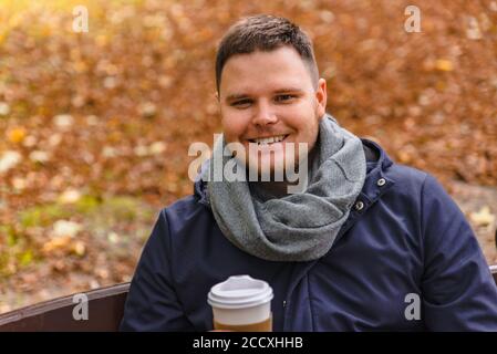 man drinking coffee outdoors autumn season Stock Photo