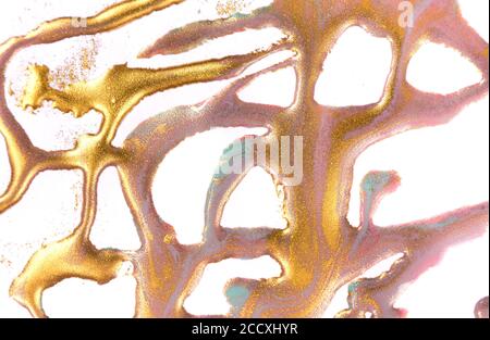 Gold and pink stains on white paper background. Stock Photo