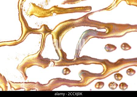 Gold stains on white paper background. Stock Photo