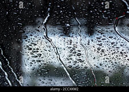 Macro abstract art view of water droplets on the glass windshield of an automobile during a car wash Stock Photo