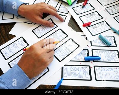 The UX designer develops web mobile application. Stock Photo