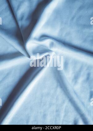 Star like circular shape pattern on silk fabric, handmade foldings on cloths, elegant blue toned. Useful for wallpaper. Stock Photo