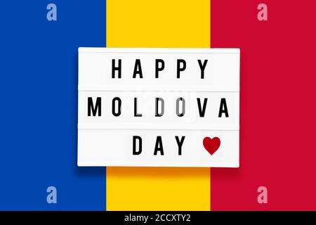 HAPPY MOLDOVA DAY written in a lightbox on a background of Ukraine flag color. Independence day concept. Stock Photo