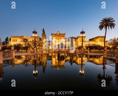 Archaeological Museum of Seville reflected in a fountain, dusk, Plaza de America, Seville, Andalusia, Spain Stock Photo