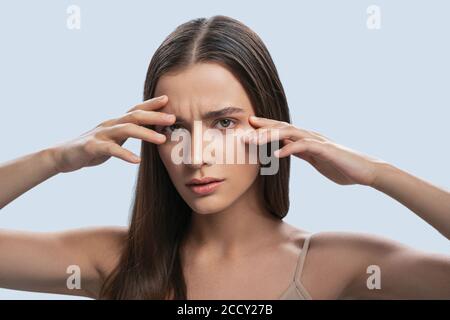 Sad dispirited woman staring in front of her Stock Photo