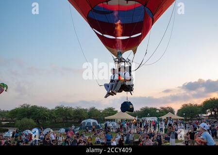 Tandem hot air balloon A man and woman sit on a seat
