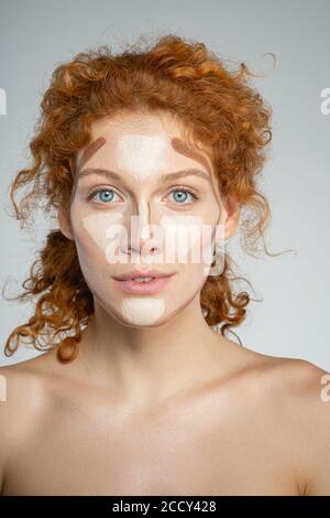 Young woman choosing the right cosmetic product Stock Photo