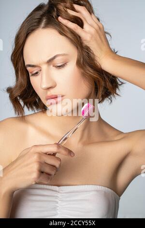 Upset young Caucasian dark-haired female looking down Stock Photo