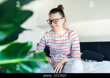 young tutor woman in headphones having video call working on laptop remotely home. online distance education at quarantine self isolation. student tal Stock Photo
