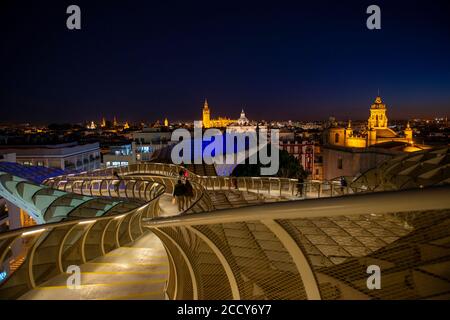 View over Sevilla from Metropol Parasol at night, Cathedral of Sevilla with tower La Giralda, Iglesia del Salvador and Iglesia de la Anunciacion Stock Photo