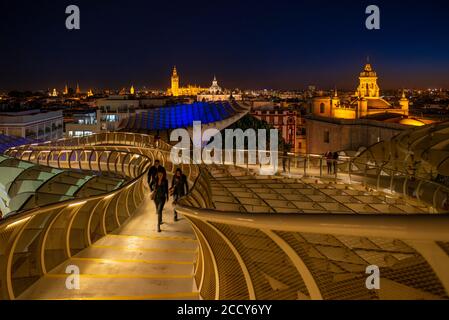 View over Sevilla from Metropol Parasol at night, Cathedral of Sevilla with tower La Giralda, Iglesia del Salvador and Iglesia de la Anunciacion Stock Photo