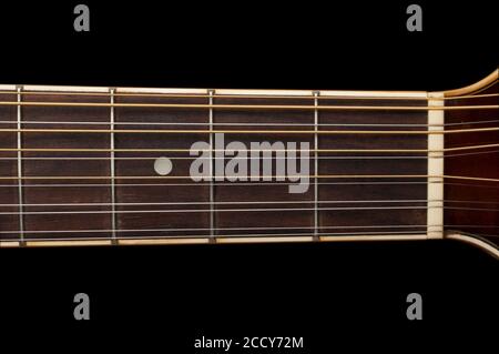 Detail of a 12 string guitar fretboard on black background Stock Photo
