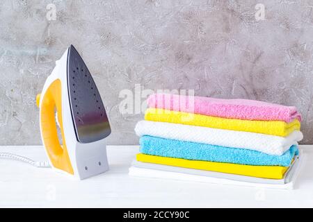 Close up of iron and towels on ironing board Stock Photo