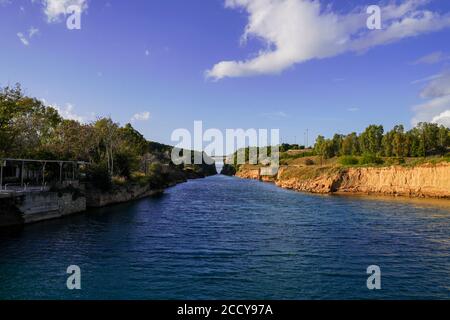 The Corinth Canal connects the Gulf of Corinth in the Ionian Sea with the Saronic Gulf in the Aegean Sea. It cuts through the narrow Isthmus of Corint Stock Photo