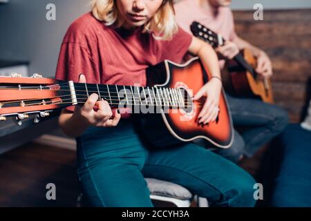 lovely couple playing the guitar at home together, love. leisure time Stock Photo