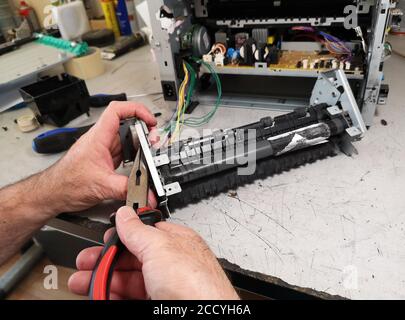 Close up shot of a technician working on a printer Stock Photo