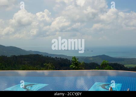 large pool overlooking the sea among tropical greenery Stock Photo