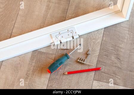 Hinge on the white door frame Stock Photo
