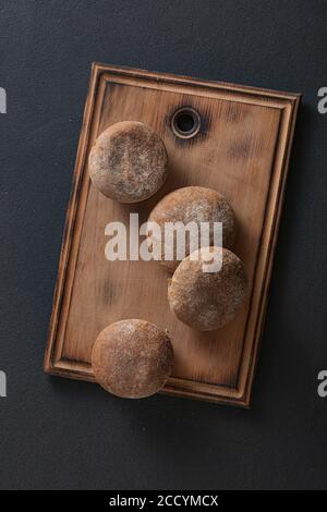 Italian buns on kitchen board top view. Stock Photo