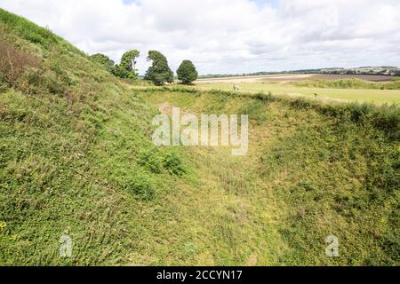 Deep defensive ditch and rampart at Old Sarum castle, Salisbury, Wiltshire, England, UK Stock Photo