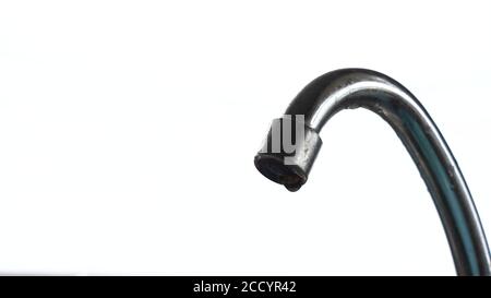 Tap water dripping. Chrome plated mixer tap isolated on white background. Waste drops of water. Water drips from the tap. copy space Stock Photo